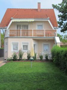 a large house with a large yard in front of it at Lili nyaralóház in Gyenesdiás