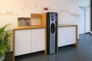 a refrigerator sitting next to a counter in a room at easyHotel Amsterdam Zaandam in Zaandam