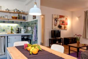 a kitchen with a table with fruit on it at Stone house Apartment Pelago in Jelsa