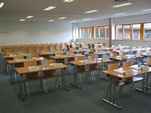 un aula vacía con escritorios y sillas. en Gästehaus der LK-Technik Mold, en Mold