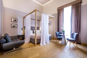 a hotel room with a bed and a large mirror at La Torre del Cestello - Residenza d'epoca in Florence