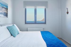A bed or beds in a room at Elysium Seaview Oasis