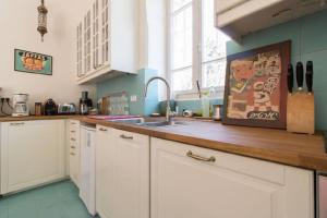 a kitchen with white cabinets and a sink at Brand New Gem In Talbiyeh in Jerusalem