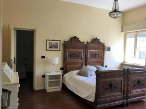a bedroom with a large wooden bed and a window at Attico vista mare in Pescara