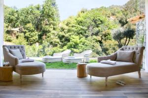 a living room with chairs and a large window at Casale Panayiotis in Kalopanayiotis