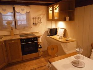 a kitchen with a table and a stove top oven at Vier Jahreszeiten Idyll in Schuttertal