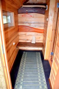 an inside of a sauna with a wooden wall at Pērkonu namiņš in Balvi