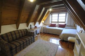 ein Wohnzimmer mit einem Sofa und einem Bett in der Unterkunft Apartament Araneu in Vielha e Mijaran