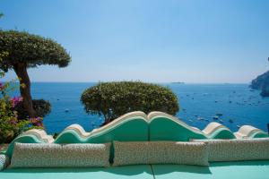 a large book sitting on a bench overlooking the ocean at Hotel Marincanto in Positano
