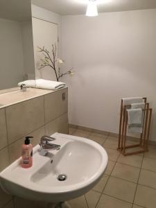 a bathroom with a white sink and a mirror at Eberl Hotel Pension München Feldmoching in Munich