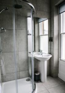 a bathroom with a shower and a sink at Spa Apartments in Harrogate