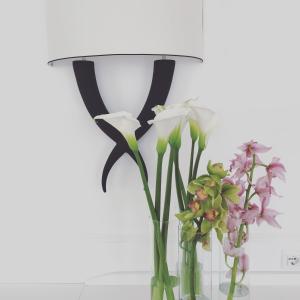 a vase filled with flowers sitting next to a lamp at Hotel Marincanto in Positano