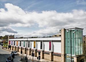 a building with colorful windows on the side of a street at Spa Apartments in Harrogate