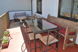 einen Balkon mit einem Glastisch und Stühlen in der Unterkunft Casa rural Puente Mocho in Ledesma