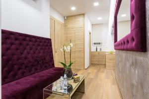 a living room with a purple couch and a table at Central Pearl by Nono Ban Rooms in Split