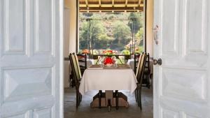 a dining room with a table with a white table cloth at Casale Panayiotis in Kalopanayiotis