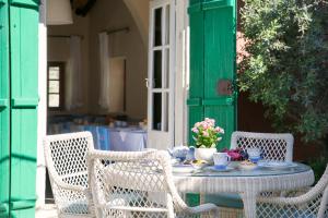 a table with chairs and a table with flowers on it at Casale Panayiotis in Kalopanayiotis