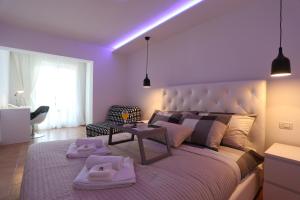 a bedroom with a large bed with purple lighting at Monte & Paradiso in Pula