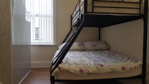 a bedroom with a bunk bed with a bedspread at Blackpoolholidaylets Charles Street in Blackpool