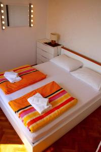 a bedroom with two beds with towels on them at Apartment Arbanasin in Dubrovnik
