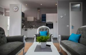a living room with two couches and a table at MASTER apartman in Sisak
