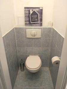 a bathroom with a toilet and a sign that reads have a home here at Riverview Apartment Bratislava in Bratislava