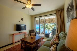 a living room with a couch and a table at The Palapa House in San Pedro