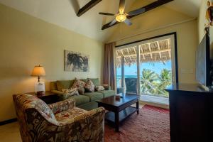 a living room with a couch and a window at The Palapa House in San Pedro