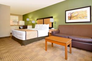 a hotel room with a bed and a couch at Extended Stay America Suites - Orange County - Irvine Spectrum in Irvine +37 photos