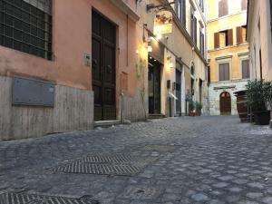 a city street with buildings and a clock on the wall at Casawally in Rome