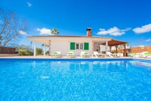 a villa with a swimming pool in front of a house at Rodriguez De La Fuente 19 (Sin Nombre) in Playa de Muro