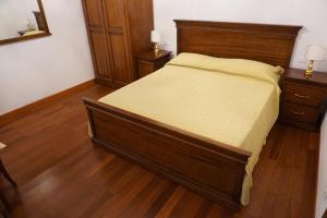 a bedroom with a wooden bed and two night stands at B & B Nina in Venice +14 photos