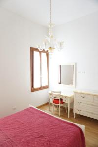 a bedroom with a bed and a desk and a mirror at B & B Nina in Venice