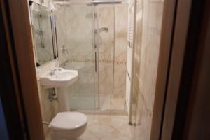 a bathroom with a shower and a toilet and a sink at B & B Nina in Venice