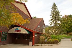 a building with a sign for a restaurant at Club Wyndham Smugglers' Notch Vermont in Jeffersonville