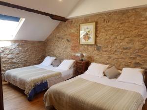En eller flere senge i et værelse på Domaine de Vareilles