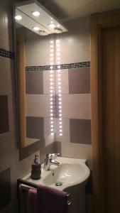 a bathroom with a sink and a mirror at Comodità città-mare Cinque Terre in La Spezia