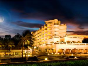 a large white building with lights in front of it at The Gateway Hotel Beach Road Visakhapatnam in Visakhapatnam