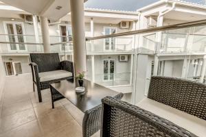 a balcony with two chairs and a table at Palotel Gouvia Hotel in Gouvia