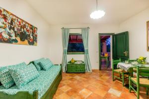 a living room with a couch and a table at Residence Sos Alinos in Cala Liberotto +14 photos