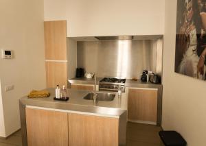 a kitchen with a sink and a stove at Y & L villa in Antwerp