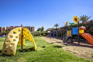 a playground with colorful play equipment in a park at Palm Appart Hôtel Marrakech in Marrakech