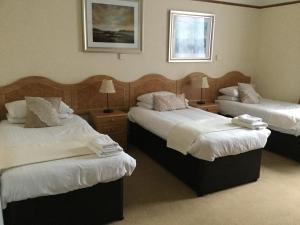 Кровать или кровати в номере Woodlands Guest House