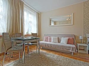 a living room with a couch and a table at Apartament Neptun in Gdańsk