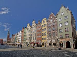 a group of buildings on a street in a city at Apartament Neptun in Gdańsk