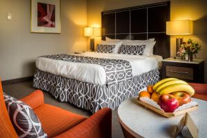 a hotel room with a bed and fruit on a table at Olyver Hotel in Los Angeles