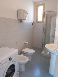 a bathroom with a washing machine and a toilet at 35G Borgonovo in Pizzo +9 photos