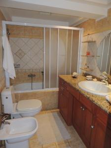 a bathroom with a toilet and a sink and a tub at Christine Villa Pefkos in Pefki Rhodes