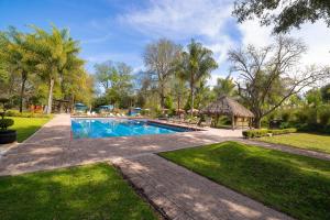a swimming pool in a yard with a gazebo at El Marques Hacienda in Guanajuato