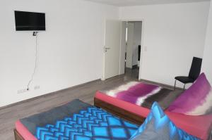 a living room with a bed and a couch at SoNi Apartment in Dieburg